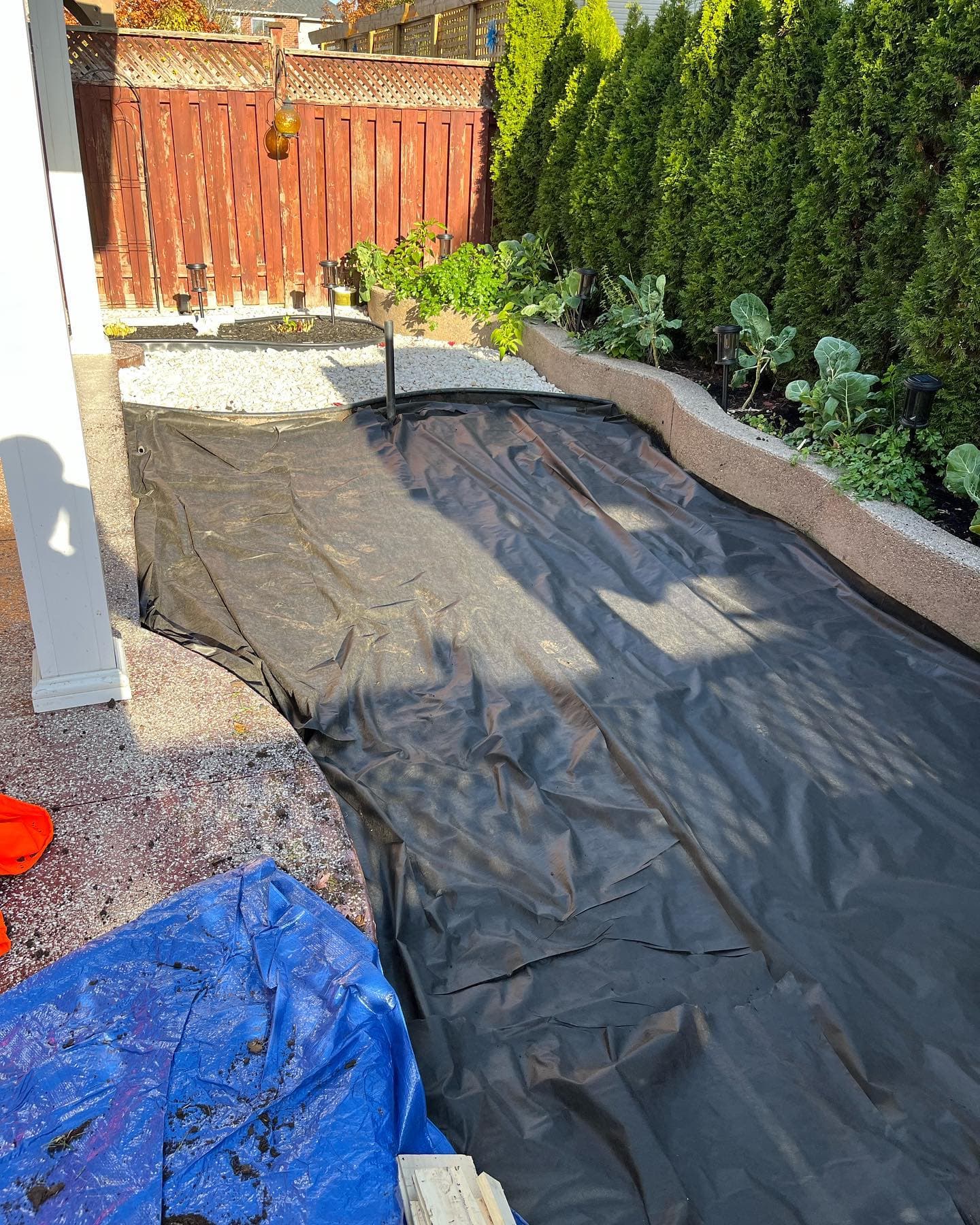 Side yard with weed barrier laid down before turf installation
