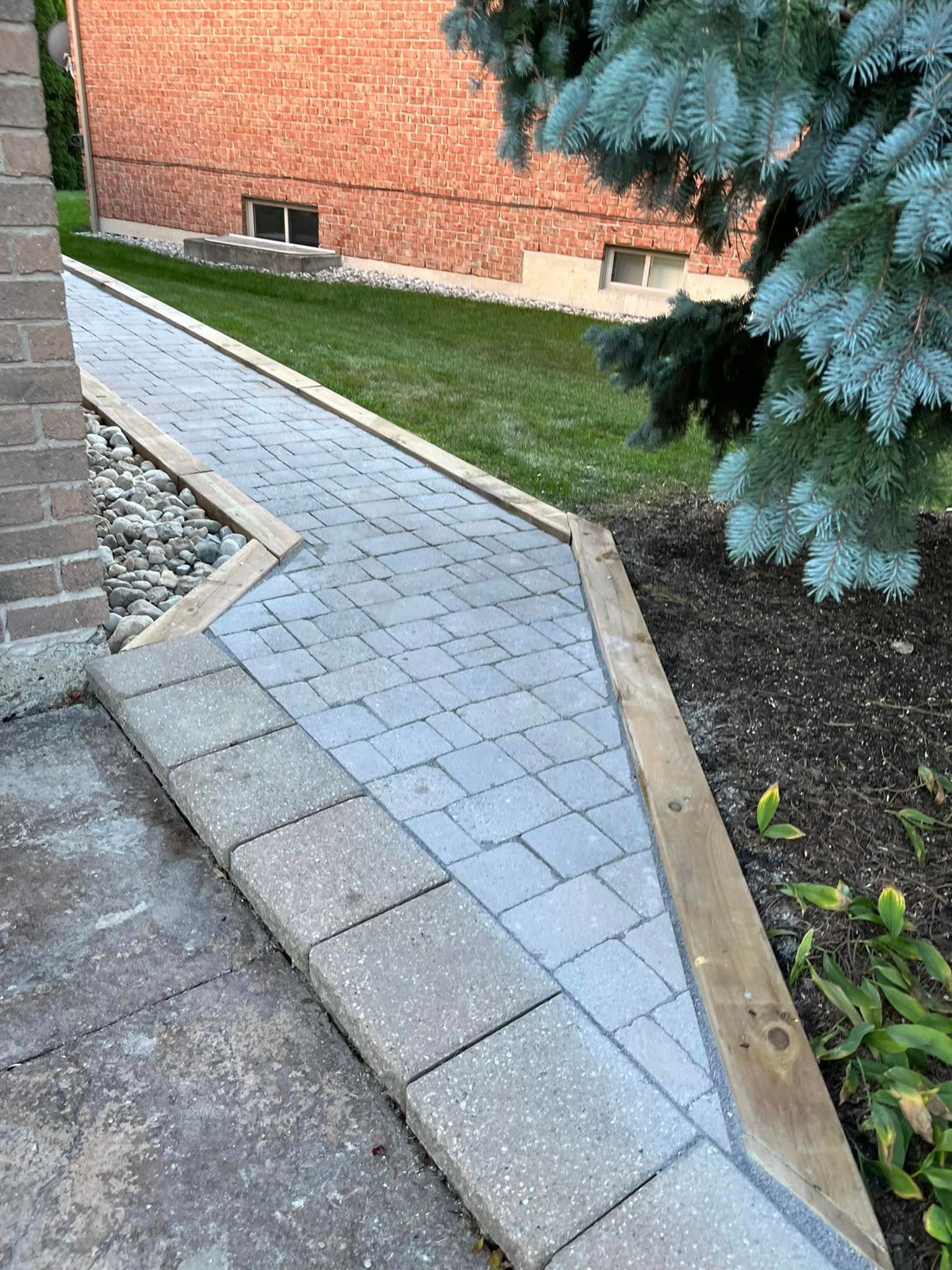 Paver walkway with cedar edging and river-rock border